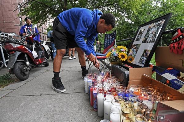 Friends and family gather around a growing memorial, including wife Orlyanis Verez (black hoodie), near the location wher<em></em>e Eric Duprey was struck by a thrown object by an NYPD officer during a  pursuit