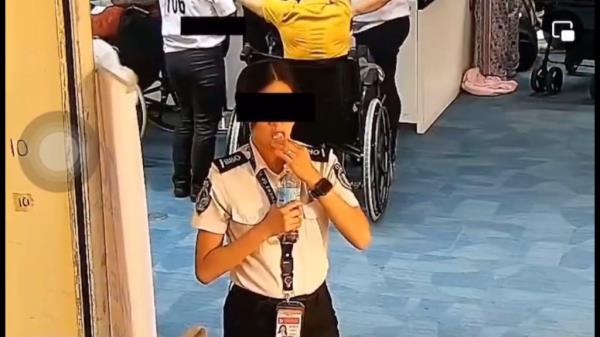 A security officer in a Philippines airport is seen shoving what's been alleged as $300 in dollar bills in her mouth.