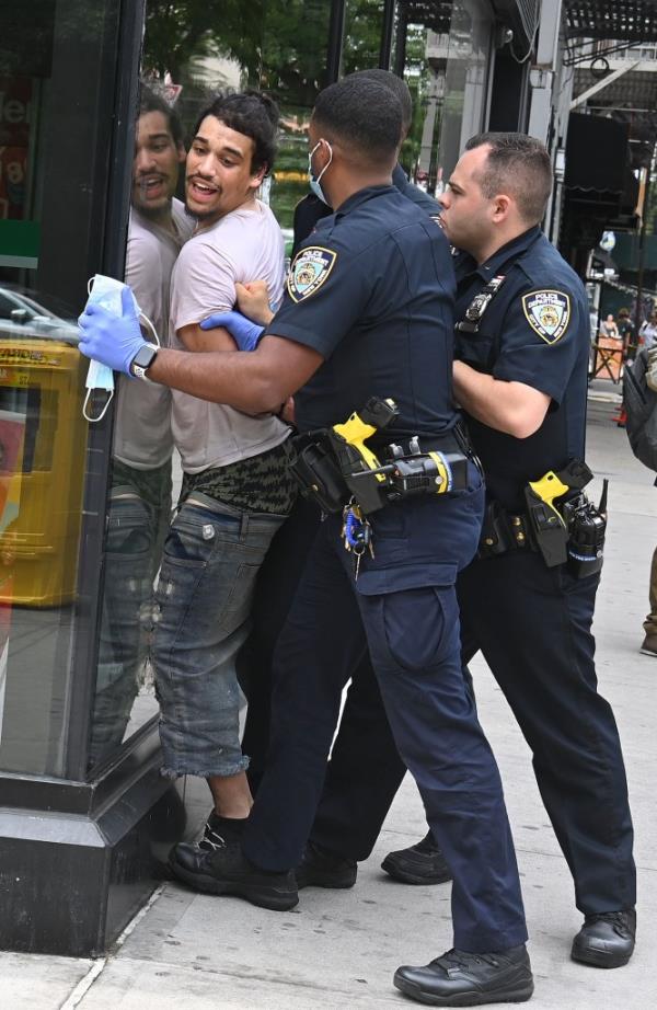 New York- NYPD officers subdue apprehended shoplifter who kept trying to escape outside Target on  East 14th St.