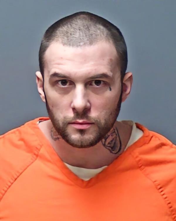 A booking photo of Adam Mo<em></em>ntgomery wearing an orange prison uniform. 