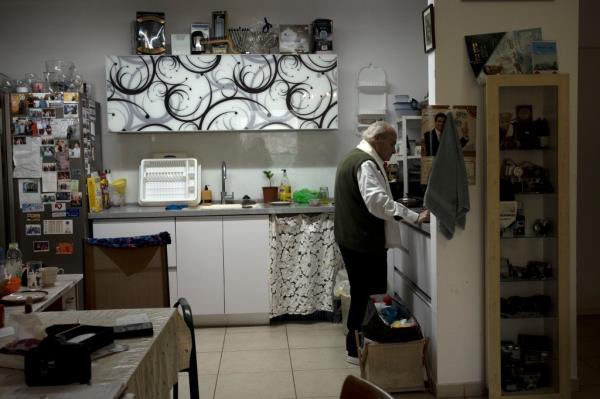 Gad Partok, 93, prepares coffee in the kitchen of his home in Ashkelon, southern Israel. 