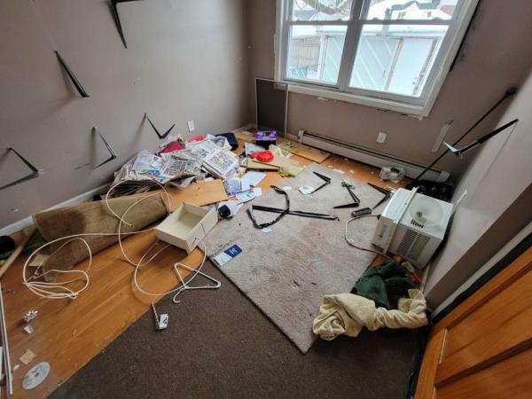 Trash, newspapers, and other items left behind in a room