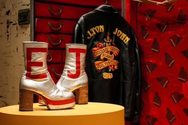 Elton John's silver platform boots with an E and J on them displayed on a table during an auction preview at Christie's in New York City.