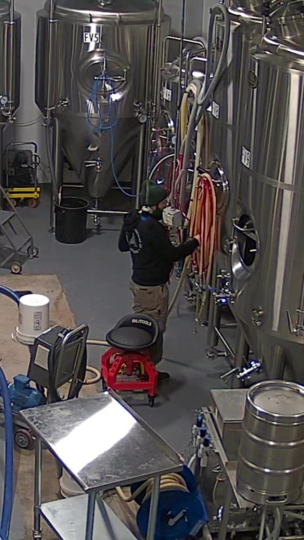 Employee at beer tank. 