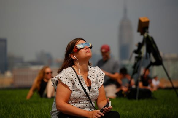 A girl watching the eclipse. 