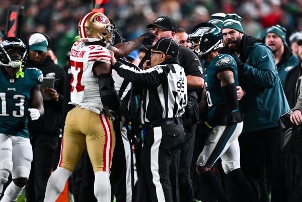 San Francisco 49ers Linebacker Dre Greenlaw (57) strikes Philadelphia Eagles Chief Security Officer Dom DiSandro in the second half during the game between the San Francisco 49ers and Philadelphia Eagles on December 03, 2023 at Lincoln Financial Field in Philadelphia, PA. 