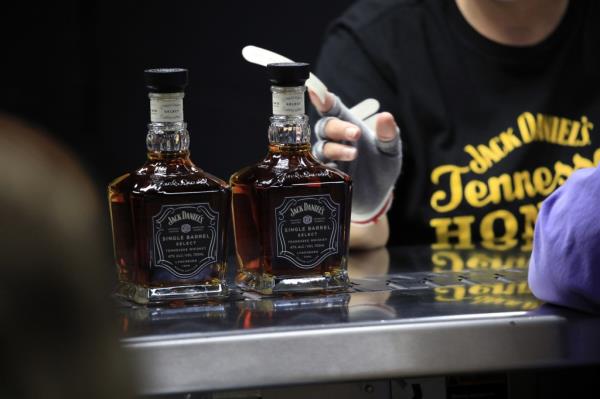 Workers attaching labels to bottles of Jack Daniel's Single Barrel Select Tennessee Whiskey at the company's distillery in Lynchburg, Tennessee.