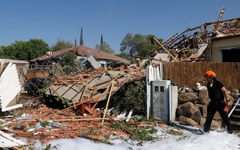 Firefighters inspect the damage in Katzrin in the Golan heights