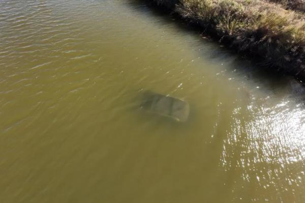 Car submerged in canal. 