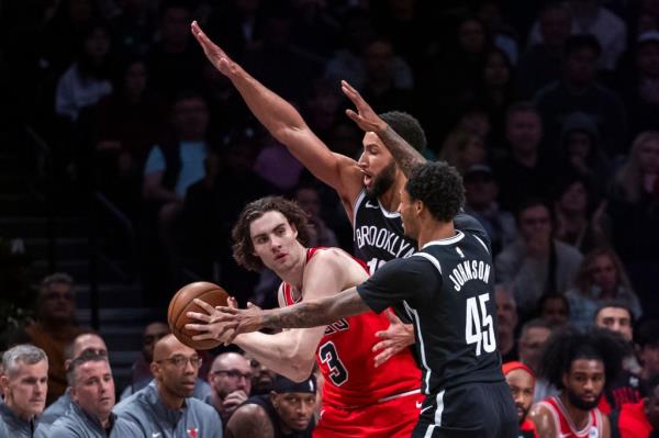 Ben Simmons and Keon Johnson (45) try to stop Josh Giddey from making a pass during the Nets' w